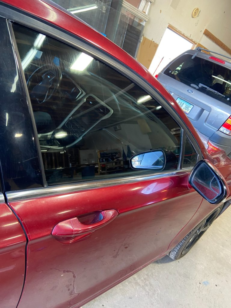 After automotive acid wash by E.A. Glass: door glass restored to clear, spot-free clarity